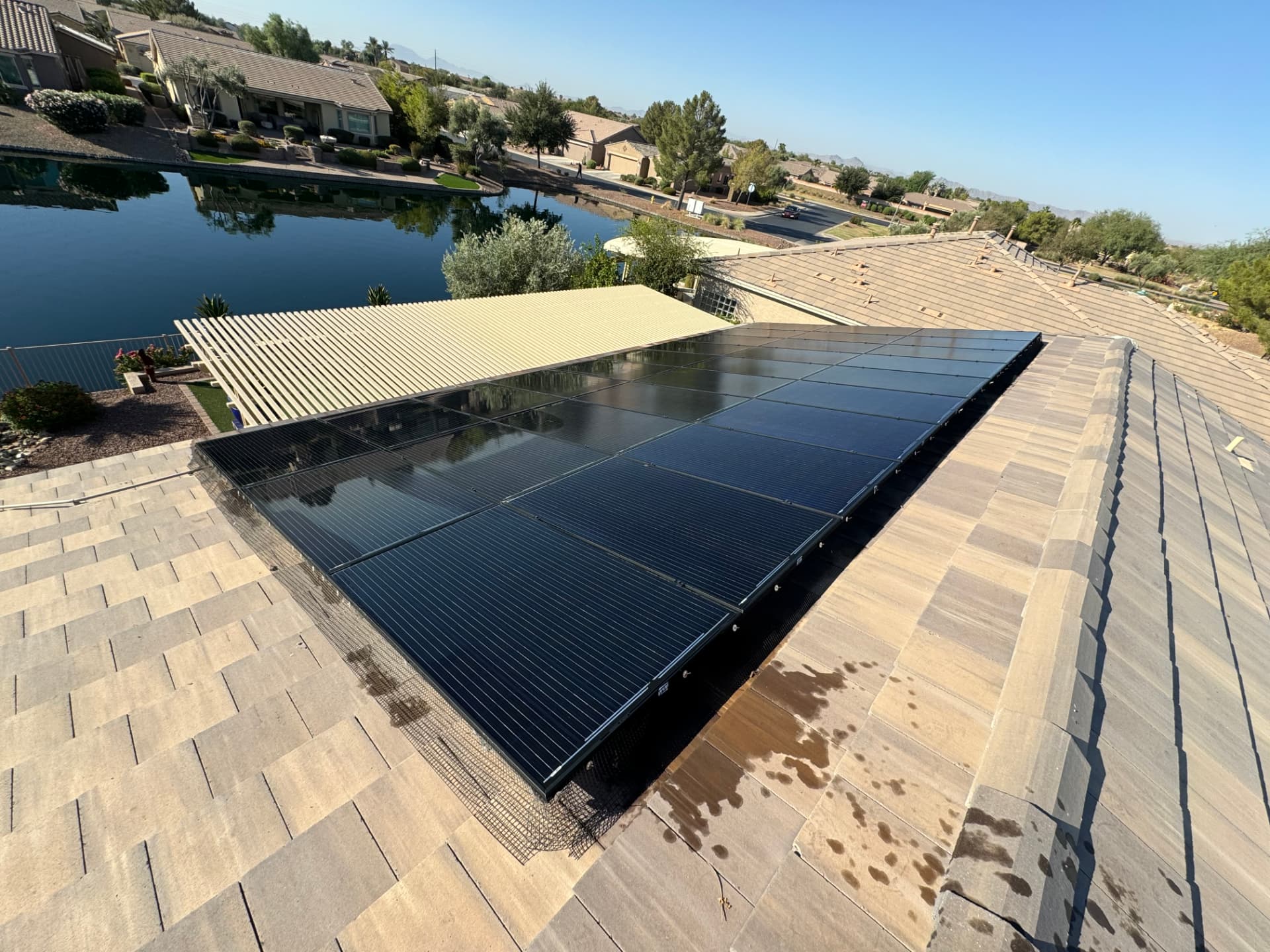 Glossy clean solar panels on a lakeside home